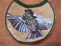 beaded bird on hide.