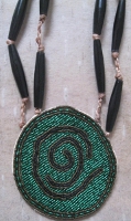 beaded necklace featuring petroglyth.